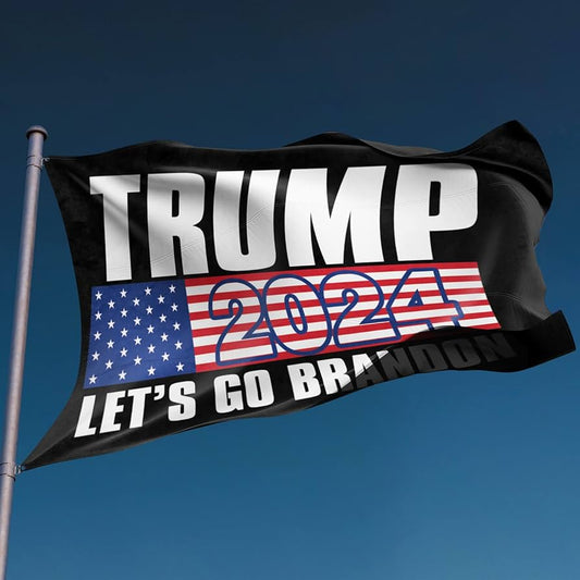 Trump 2024 campaign flag waving proudly against a clear blue sky, highlighting the patriotic colors and bold lettering