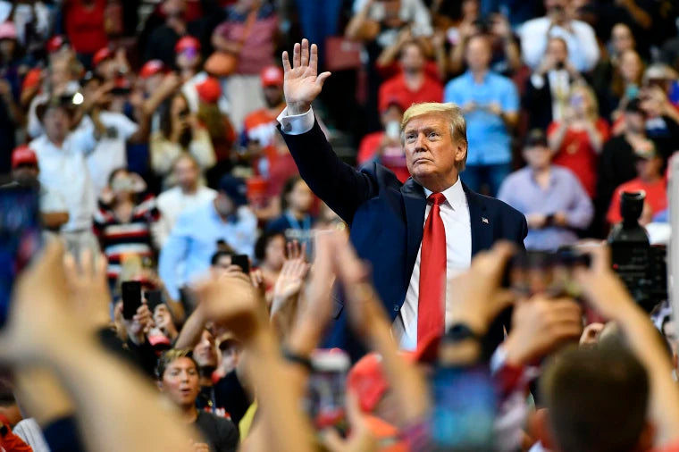 Trump 2024 campaign flag waving at a rally