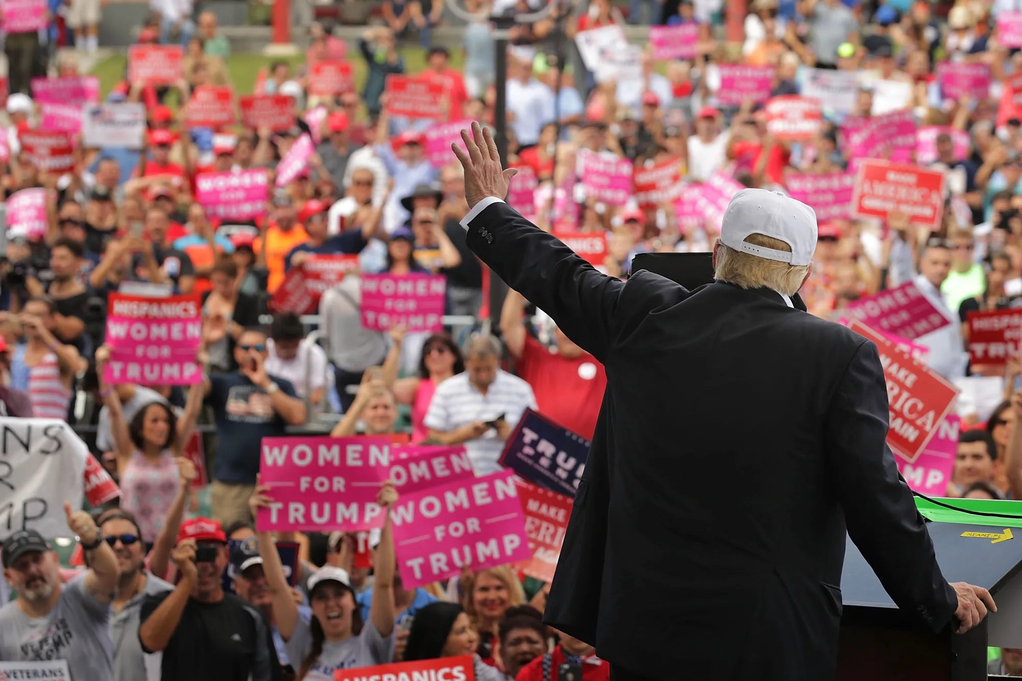 President Donald Trump waving in a display of American pride, symbolizing the unity and strength of Great America & Faith Merch supporters.